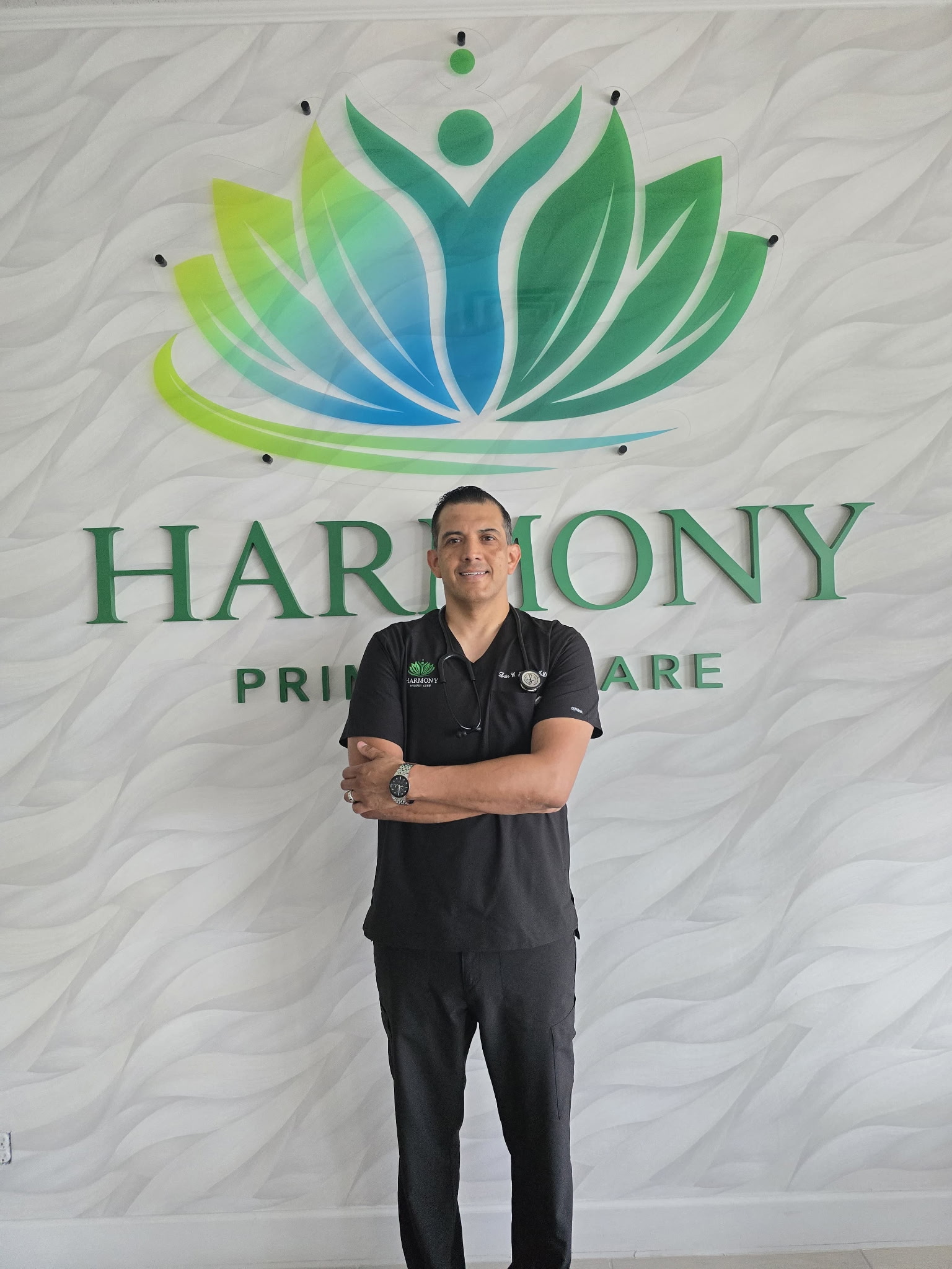 Dr. Luis Rochin in black scrubs